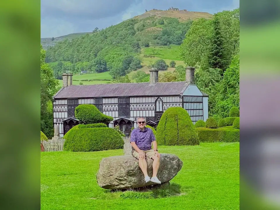 Oak Hill Director of Bands Bryce Werntz traveled abroad to Wales over the summer break. While there, he announced that he was bringing back the “Eisteddfod” to the Village of Oak Hill. He is shown sitting on a rock in the center of the Gorsedd stone circle. The prominent central stone is used for the official proclamation of the Eisteddfod and its theme in Wales. (Photo Courtesy of Bryce Werntz)
