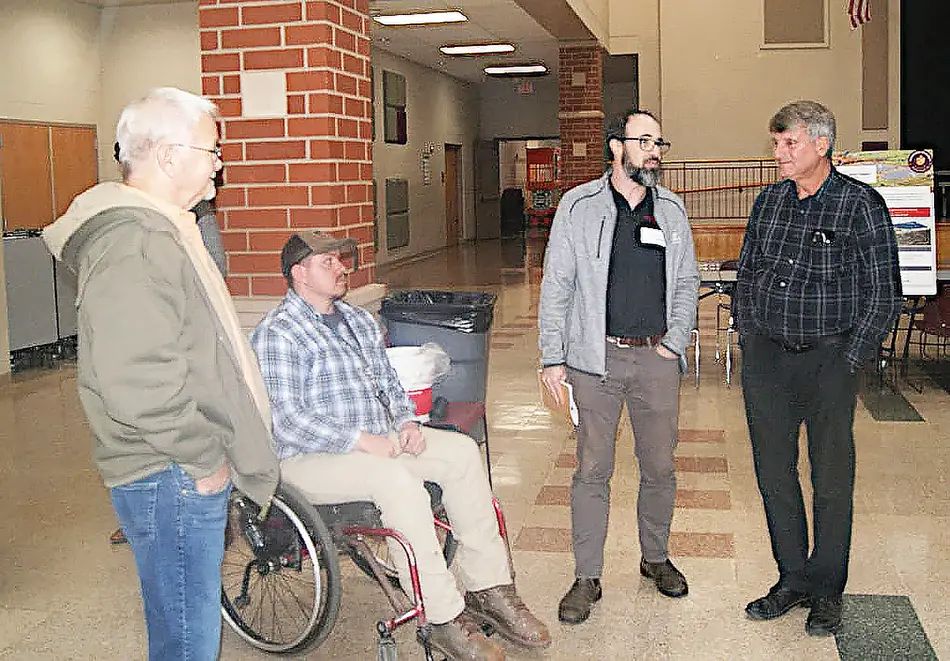 Recurrent Energy Project Manager Ryan Peck (third from left) discusses the Hamden Energy Project with Vinton County Commissioners -- from the left, Kevin Cozad Jeffery Harper III and Tim Eberts. (Telegram Photo by Red Thompson, Jr.)