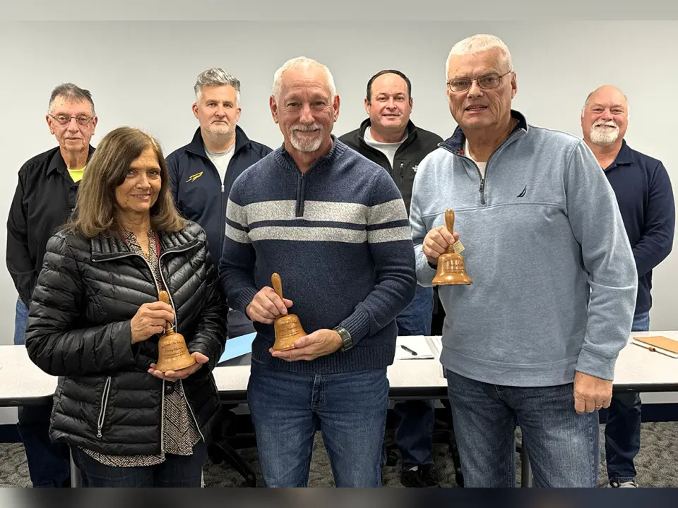 Members of the Wellston School Board are shown standing with retirees. Pictured in the front row, from the left are retirees Cathy Hatten, Dave Butcher, and outgoing Wellston School Board President Terry Gill. Standing behind, from the left are Wellston School Board Vice President Roger Rader, School Board members Adam Massie, John Jackson, and Brian Kilgour. The retirees are holding wooden bells which honor their service and dedication to the school district. (Telegram Photo by Jeremiah Shaver)
